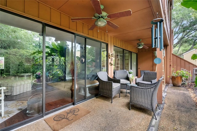 sunroom featuring ceiling fan and a healthy amount of sunlight