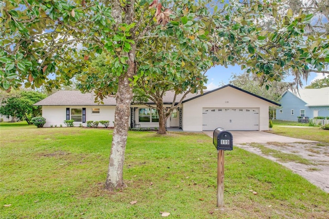 single story home featuring a garage and a front yard