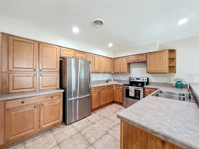 kitchen with stainless steel appliances, sink, and light tile patterned floors