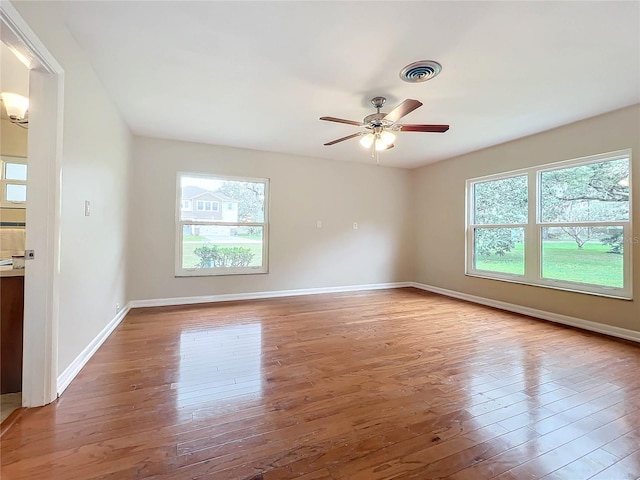 empty room featuring ceiling fan and hardwood / wood-style floors