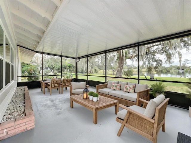 sunroom featuring a water view and wood ceiling