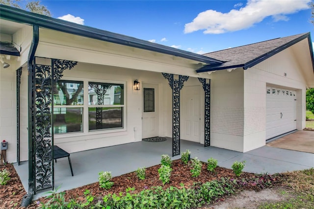 property entrance featuring a garage, concrete block siding, brick siding, and roof with shingles