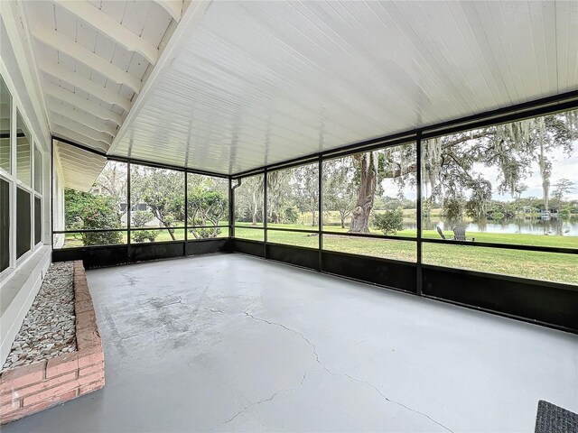 unfurnished sunroom with a water view