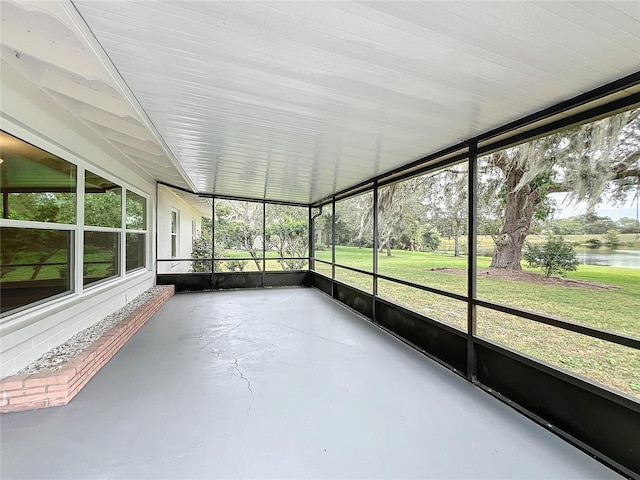 unfurnished sunroom with a water view