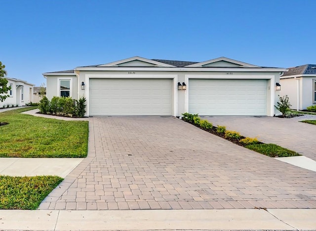 ranch-style home with a front lawn and a garage