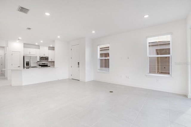 unfurnished living room with a healthy amount of sunlight