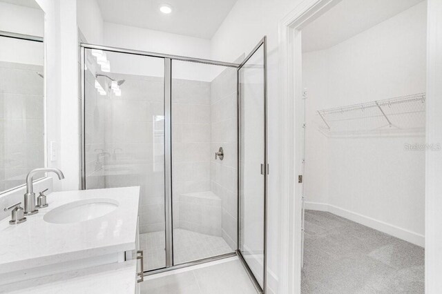 bathroom featuring vanity and an enclosed shower