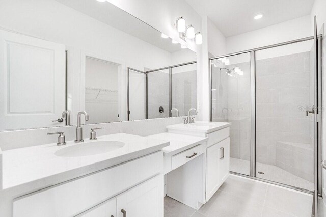 bathroom with vanity, tile patterned flooring, and a shower with door