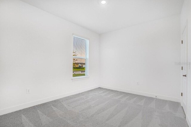 unfurnished room with light colored carpet