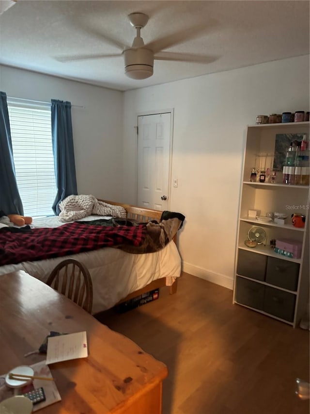 bedroom featuring hardwood / wood-style floors and ceiling fan