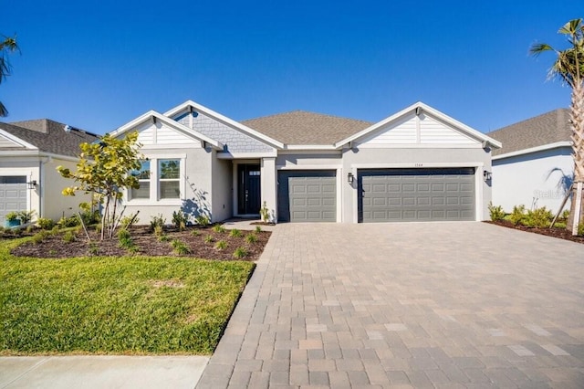 single story home with a front yard and a garage