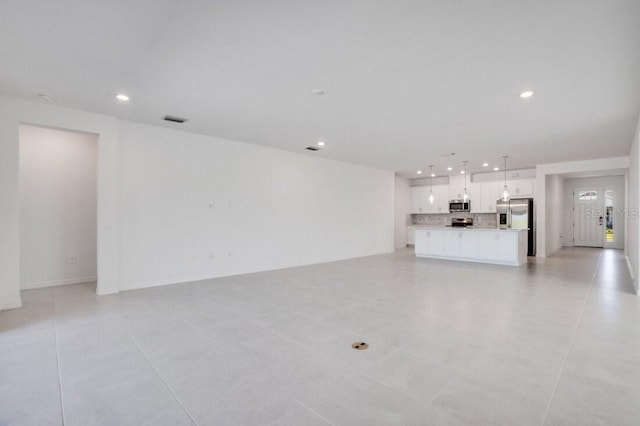 unfurnished living room with light tile patterned flooring