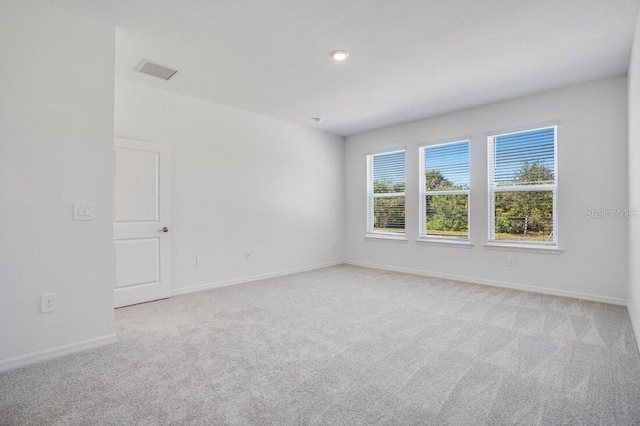 unfurnished room with light colored carpet