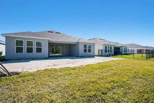 rear view of house featuring a yard