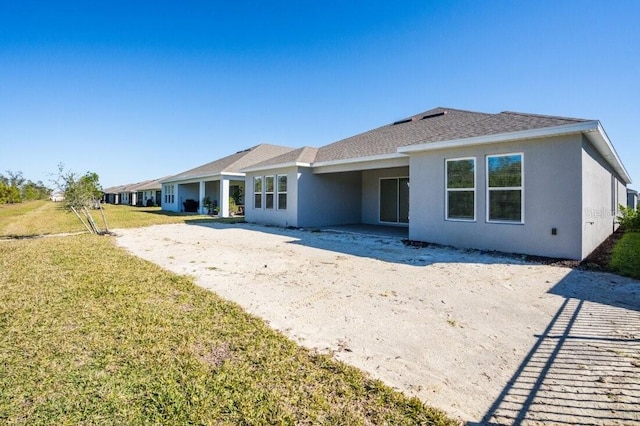 rear view of property featuring a yard