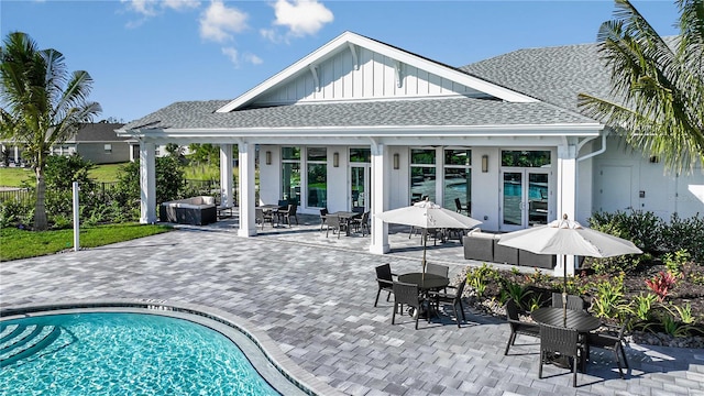 back of house featuring a patio area and an outdoor living space