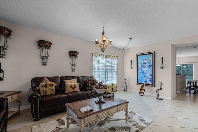 tiled living room featuring a textured ceiling and a notable chandelier