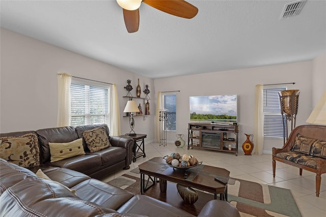 living room with light tile patterned floors and ceiling fan