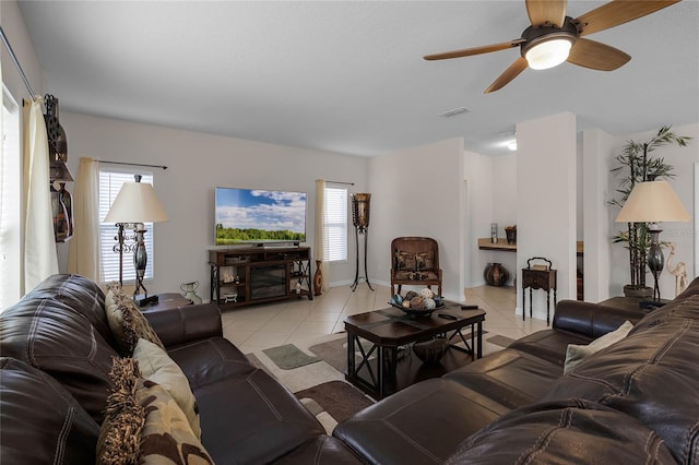 tiled living room with ceiling fan