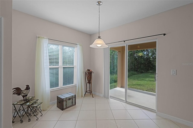 unfurnished dining area featuring light tile patterned flooring