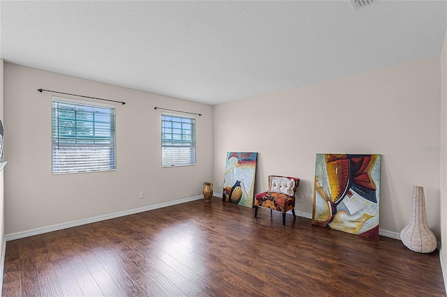 miscellaneous room featuring dark hardwood / wood-style floors and a textured ceiling