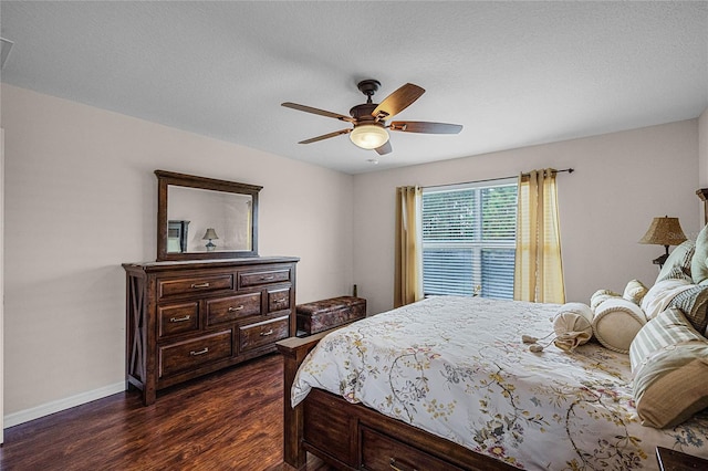 bedroom with ceiling fan, dark hardwood / wood-style flooring, and a textured ceiling