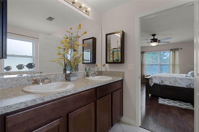 bathroom with hardwood / wood-style flooring, plenty of natural light, ceiling fan, and vanity