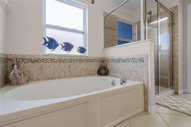 bathroom featuring tile patterned flooring, shower with separate bathtub, and tile walls