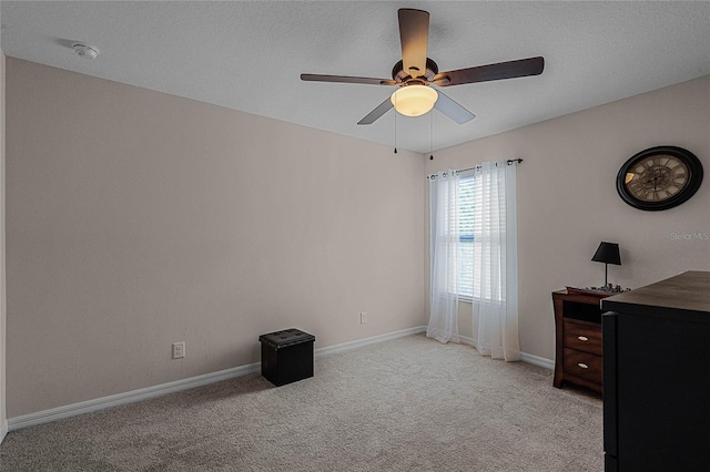 carpeted bedroom featuring a textured ceiling and ceiling fan