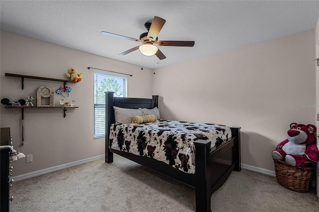 carpeted bedroom featuring ceiling fan and a textured ceiling