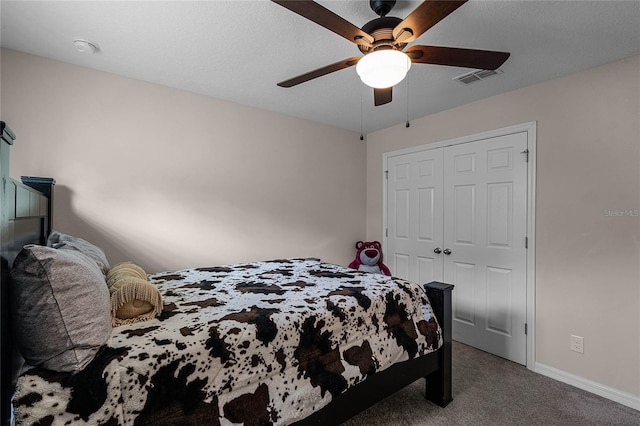 carpeted bedroom with a closet and ceiling fan