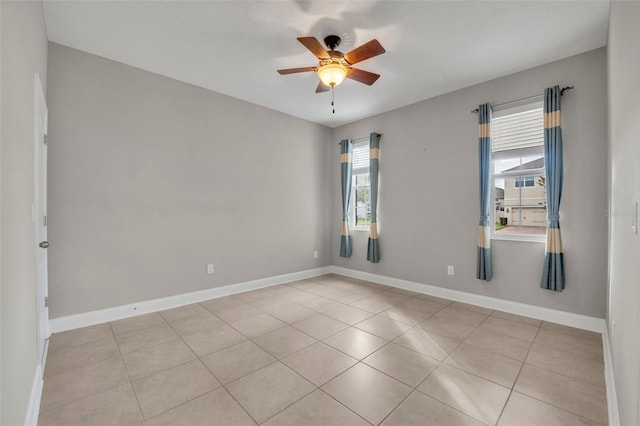 unfurnished room featuring ceiling fan and light tile patterned floors