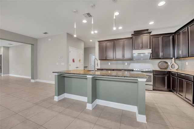 kitchen featuring a center island with sink, sink, stainless steel electric range oven, light stone countertops, and light tile patterned floors