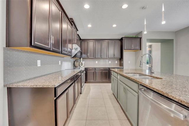 kitchen with decorative backsplash, sink, light tile patterned flooring, stainless steel appliances, and light stone counters