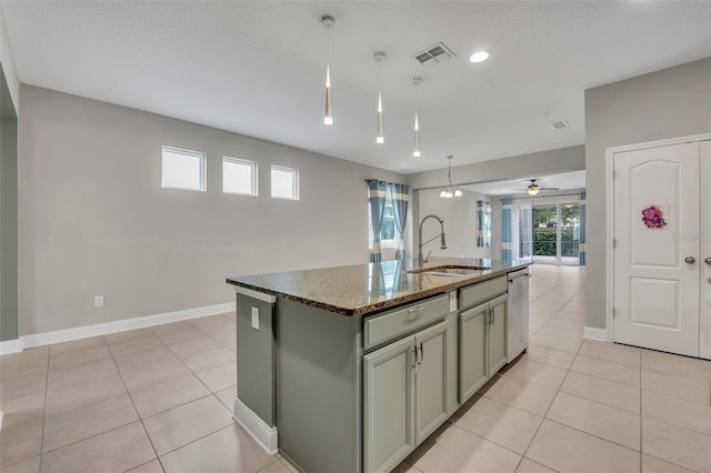 kitchen with dishwasher, decorative light fixtures, an island with sink, sink, and ceiling fan