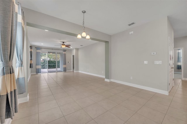 unfurnished room with light tile patterned floors and ceiling fan with notable chandelier