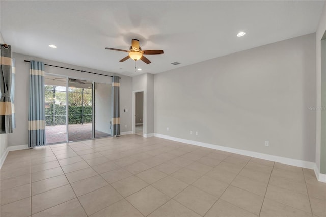 tiled empty room featuring ceiling fan