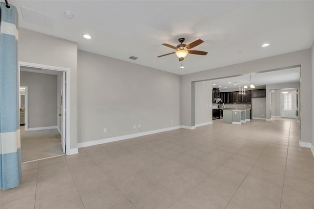 unfurnished living room featuring ceiling fan and light tile patterned floors