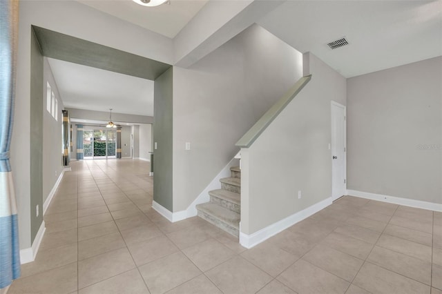 staircase featuring tile patterned floors