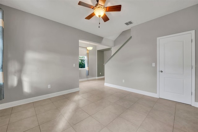 tiled spare room with ceiling fan