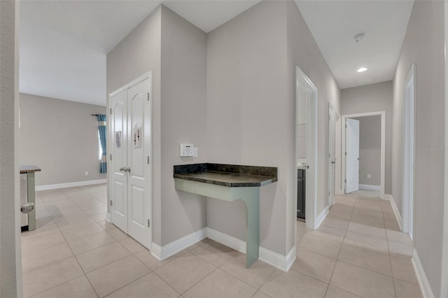 hallway featuring light tile patterned floors