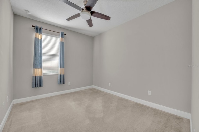 unfurnished room featuring ceiling fan, light colored carpet, and a textured ceiling