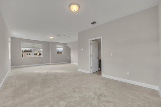 spare room featuring light colored carpet