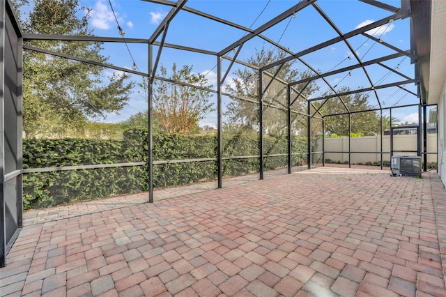 view of patio with a lanai and central AC