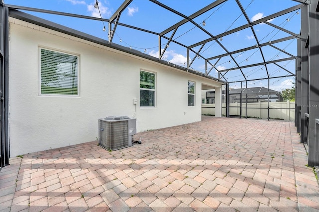 view of patio / terrace featuring a lanai and central AC