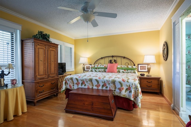 bedroom featuring ceiling fan, ornamental molding, and light wood-type flooring