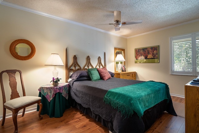 bedroom featuring hardwood / wood-style flooring, ceiling fan, ornamental molding, and a textured ceiling