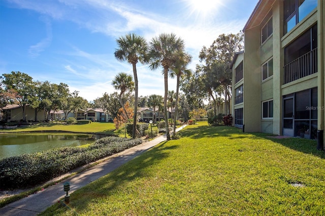 view of property's community with a yard and a water view