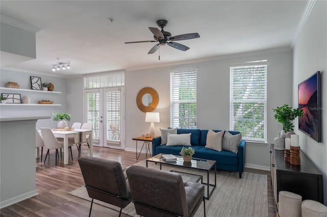 living room featuring crown molding, hardwood / wood-style floors, and ceiling fan