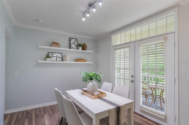 dining area featuring dark hardwood / wood-style floors, crown molding, and french doors